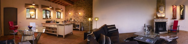A panoramic view of the small apartment's living room and kitchen